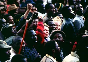 Amandla: Two young white students sit surrounded by a crowd