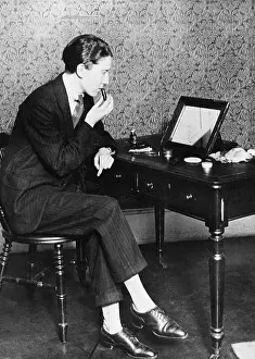 Menswear: Young woman applying makeup, 1927