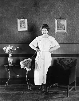 20 25: Young woman in an apron and a duster standing in