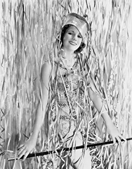 Celebratory: Young woman covered with streamers