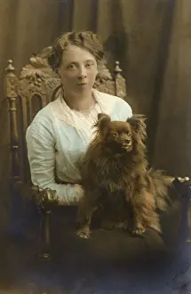 Lapdog: Young woman with dog in studio photo