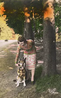 Pleated: Young woman with a German Shepherd dog, France
