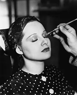 Eyeshadow: Young woman having make up done