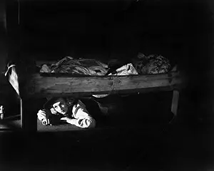 20 25: Young woman hiding under the bed