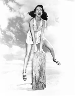 Mid Air: Young woman jumping over a hurdle