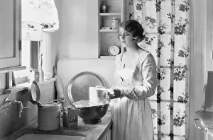Domestication: Young woman in her kitchen, baking