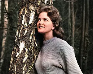 Andrew Besley: Young woman leaning against a tree