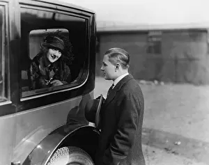 Good Bye: Young woman looking at a man through a car window