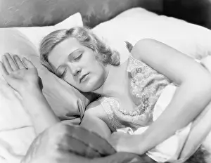 Midadult: Young woman lying in her bed sleeping