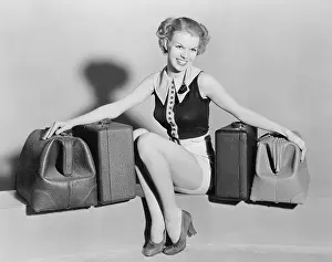 Getaway: Young woman with old bags