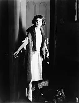 Enigma: Young woman opening the door