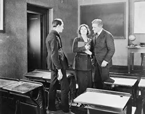 Mentors: Young woman performing for two men in a class room