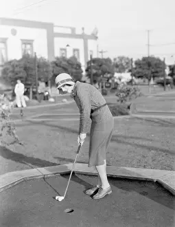 Time Off: Young woman playing mini golf