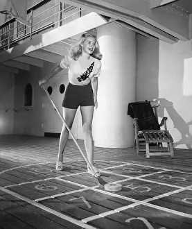 Long Haired: Young woman playing shuffleboard