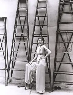 Stepladder: Young woman posing in front of ladders