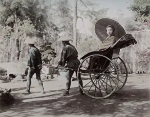Jinrikisha: Young woman being pulled in a rickshaw, Japan