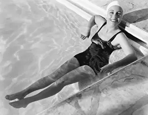 Getaway: Young woman relaxing in a pool