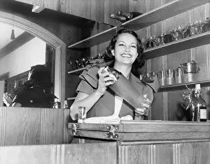 Blend: Young woman with a shaker in a bar