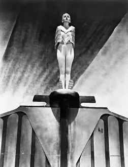 Emblematic: Young woman standing like a statue
