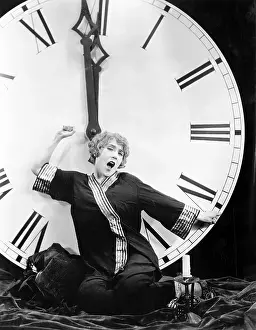 Exhausting: A young woman stretching in front of a giant clock
