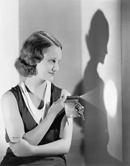 Flashlight: Young woman using a flashlight on her key chain