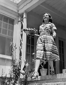 Stride: Young woman walking down steps of her terrace with