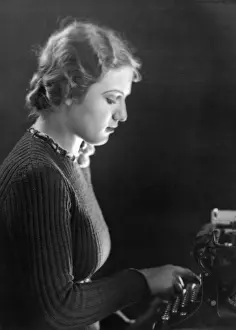Typewriter: Young woman working at typewriter, 1938