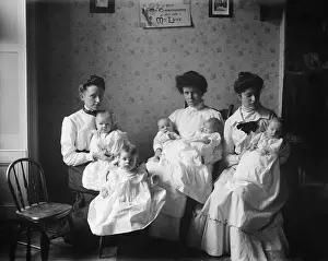 Orphanages: Three young women hold five babies at the