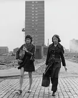 Cobblestones: Young women near a tower block
