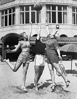 Carefree: Three young women playing with a ball on the beach