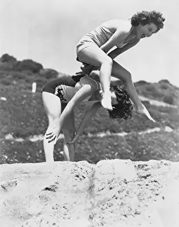 Liveliness: Young women playing leap frog