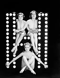 Imagining: Three young women posing with the letter H