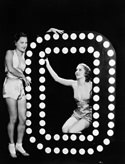 Imagining: Two young women posing with the letter O