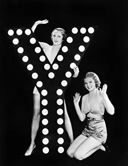Imagining: Two young women posing with the letter Y