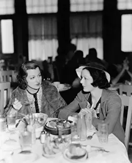 Foodstuff: Two young women sitting in a restaurant and looking