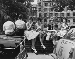 Flared: Young women sitting on a wall