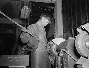 Bantam: Young worker buffing aluminum supports for