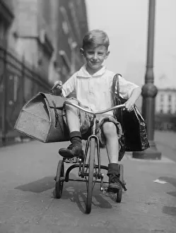 Bsloc1608: Youngster rides his tricycle on the sidewalks of