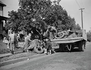 Donation: Youngsters help load a truck with scrap metal