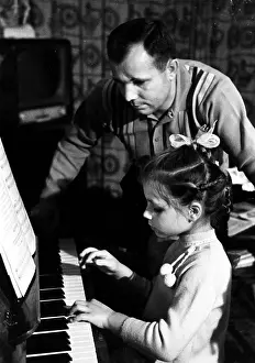 Lena: Yuri Gagarin with daughter Lena at home, 1966